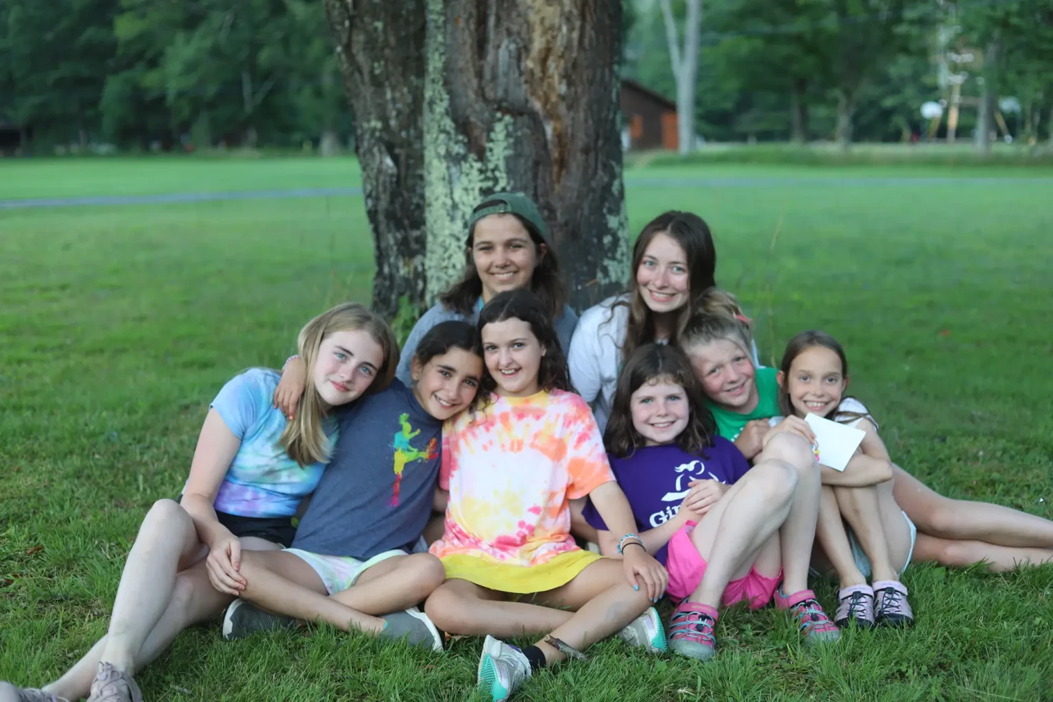 two counselors with a group of campers