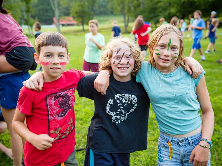 A group of young children standing next to each other