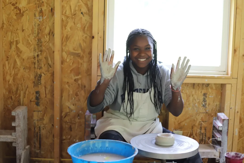 Camper doing pottery