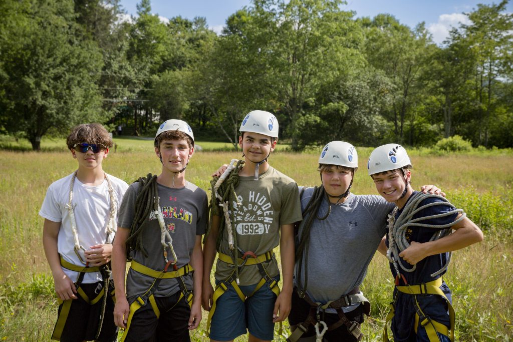 camper boys rope climbing